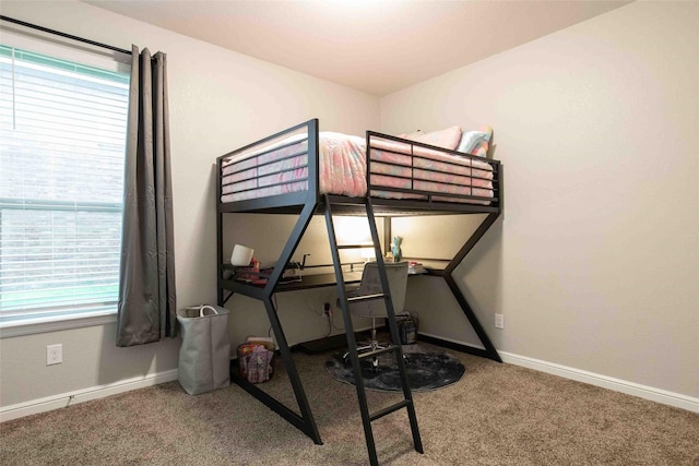 bedroom featuring baseboards and carpet