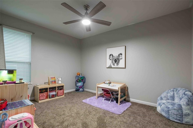 recreation room featuring carpet flooring, ceiling fan, and baseboards