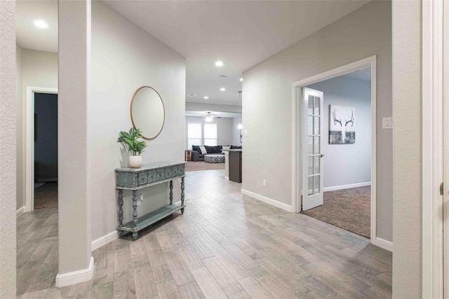 hall with recessed lighting, baseboards, and wood finished floors