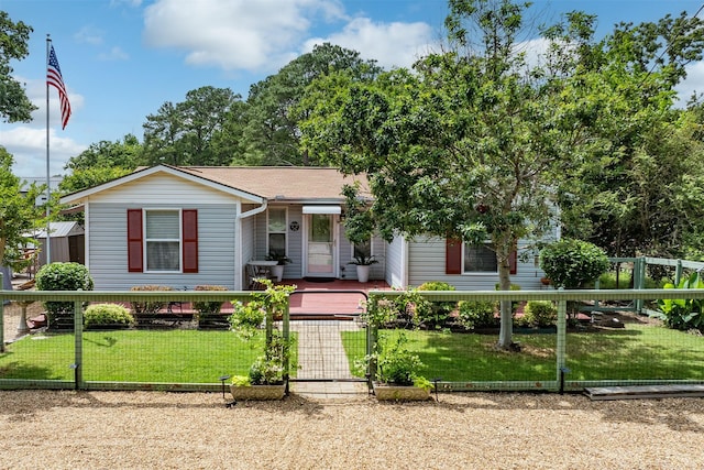 ranch-style house with a porch, a fenced front yard, a gate, and a front lawn