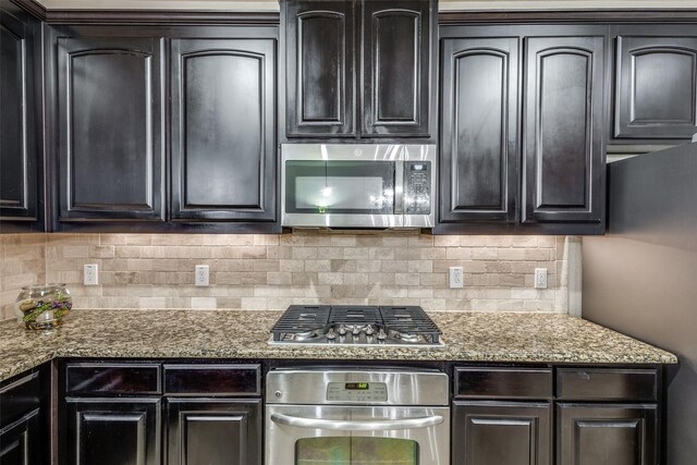 kitchen with backsplash, appliances with stainless steel finishes, and stone counters