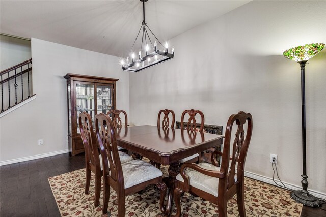 dining room with baseboards, stairs, wood finished floors, and a chandelier