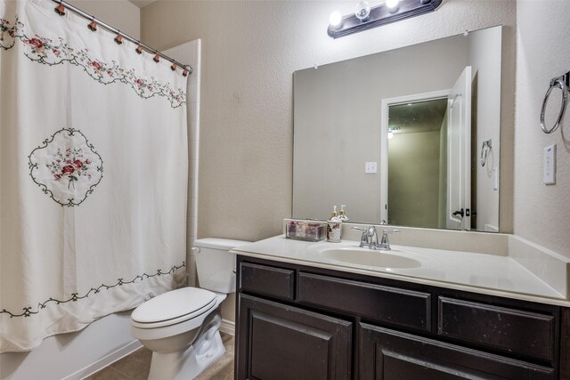 bathroom featuring vanity, tile patterned floors, shower / bath combo, and toilet