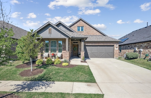 craftsman inspired home featuring an attached garage, a front yard, brick siding, and concrete driveway