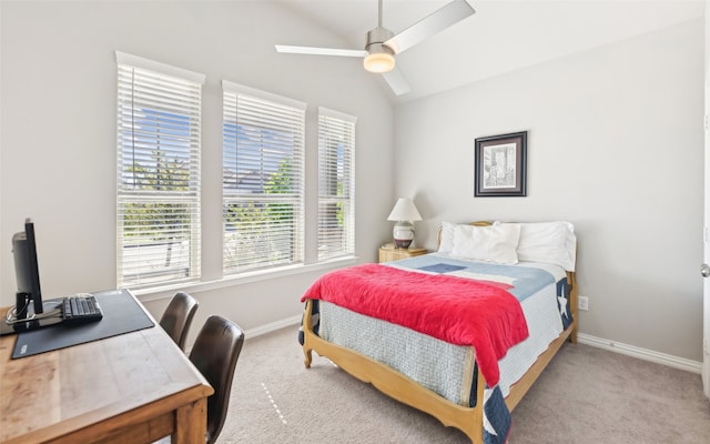 carpeted bedroom featuring baseboards, vaulted ceiling, multiple windows, and ceiling fan