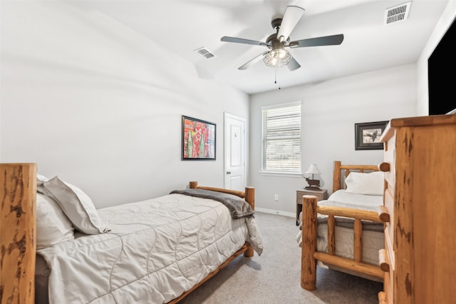 carpeted bedroom featuring visible vents, a ceiling fan, and baseboards