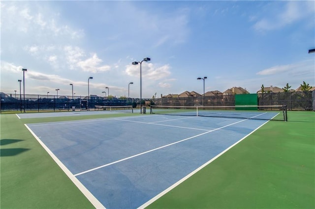 view of sport court featuring fence
