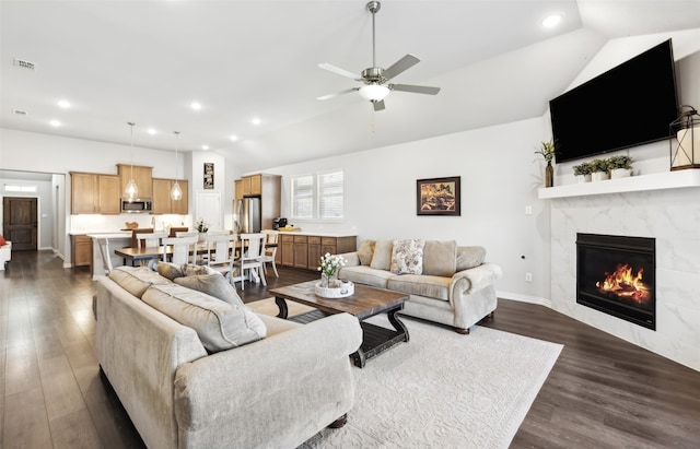 living area featuring ceiling fan, dark wood-style flooring, visible vents, a high end fireplace, and recessed lighting