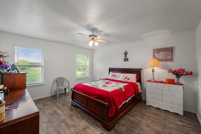 bedroom with baseboards, ceiling fan, and wood finished floors