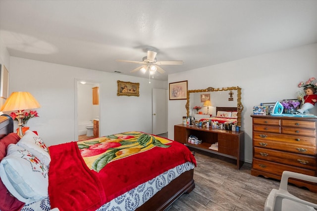 bedroom featuring ceiling fan, ensuite bathroom, and wood finished floors
