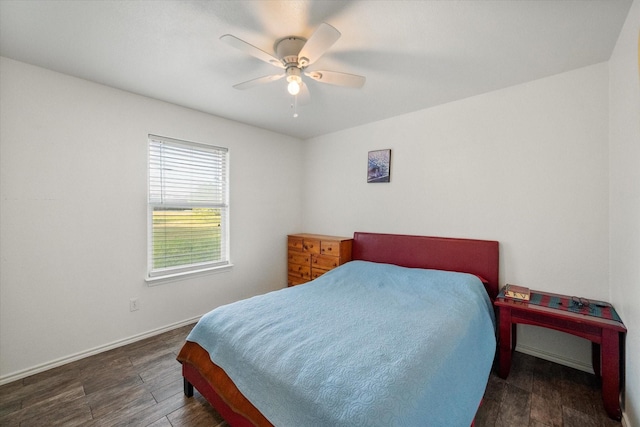bedroom with baseboards, ceiling fan, and wood finished floors