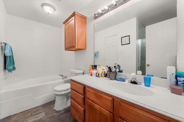 bathroom with vanity, a shower, wood finished floors, toilet, and a bathtub