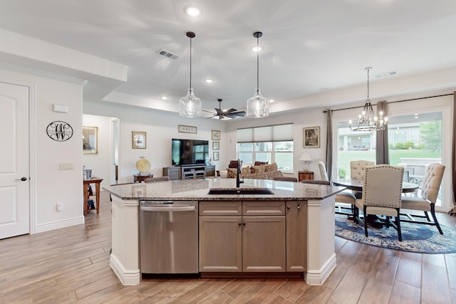 kitchen featuring a sink, ceiling fan with notable chandelier, open floor plan, stainless steel dishwasher, and visible vents