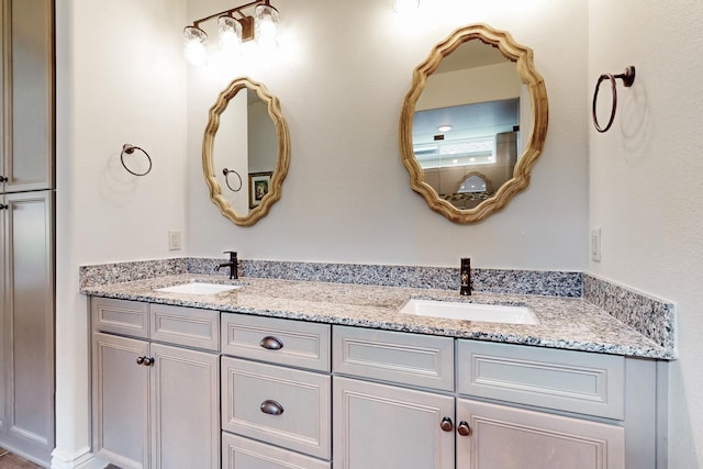 full bathroom with a sink and double vanity