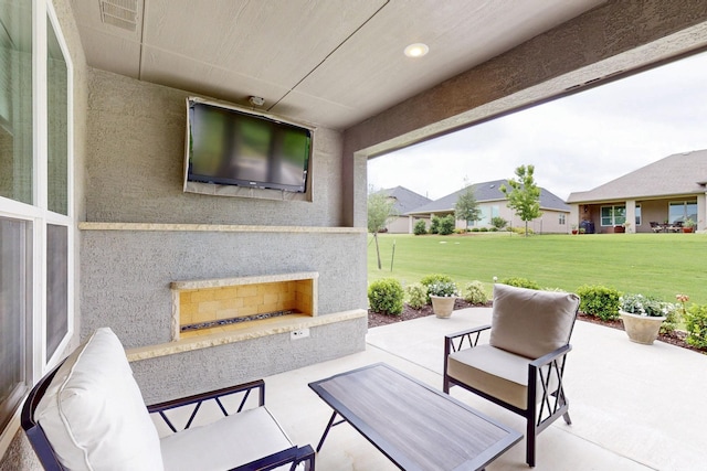 view of patio featuring visible vents and an outdoor fireplace