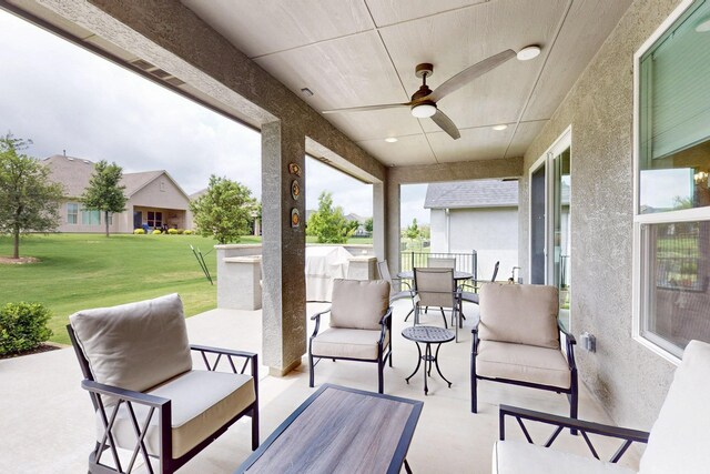 view of patio with ceiling fan, an outdoor hangout area, and outdoor dining space