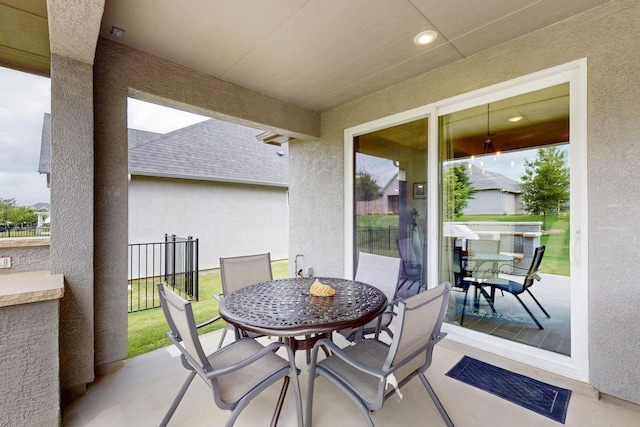 view of patio featuring fence and outdoor dining area