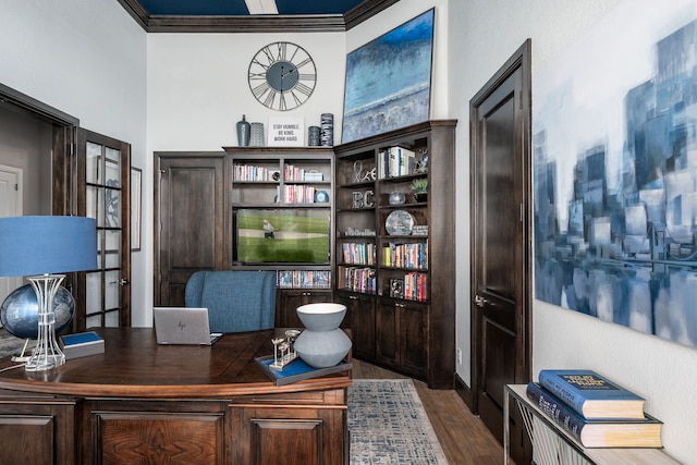 office area with ornamental molding and wood finished floors