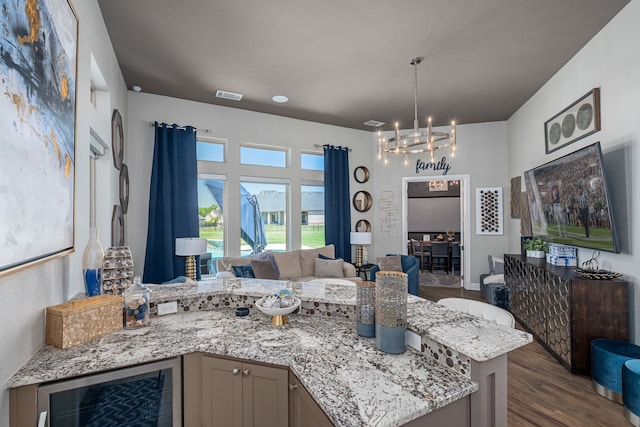 kitchen with visible vents, dark wood-style flooring, wine cooler, open floor plan, and a notable chandelier