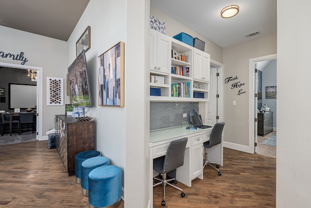office space featuring built in study area, baseboards, dark wood-style flooring, and visible vents