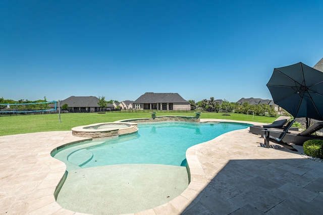 view of pool featuring a lawn, a patio, and a pool with connected hot tub