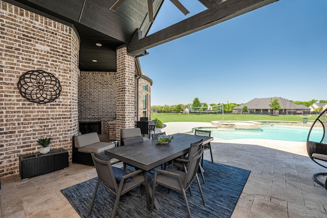 view of patio featuring a pool with connected hot tub