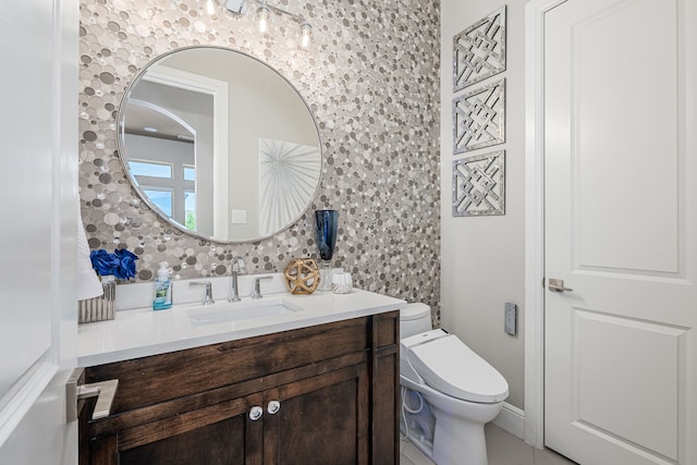 bathroom featuring toilet and vanity
