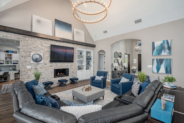4241 Tranquility Ln, Prosper, TX 75078 - living area with high vaulted ceiling, wood finished floors, arched walkways, a chandelier, and built in features