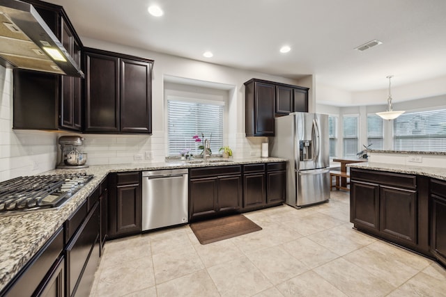 kitchen with wall chimney exhaust hood, stainless steel appliances, recessed lighting, decorative backsplash, and visible vents