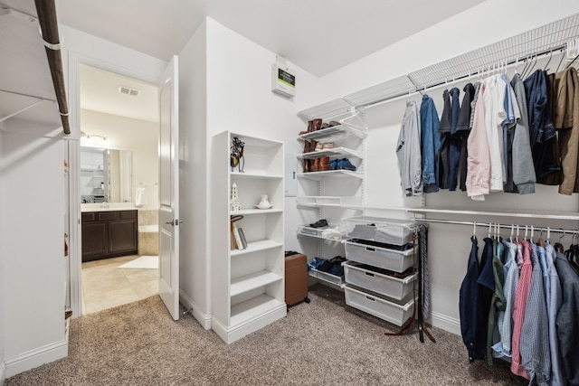 spacious closet featuring light carpet and visible vents