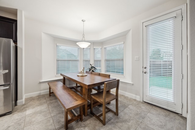 dining room featuring light tile patterned floors and baseboards