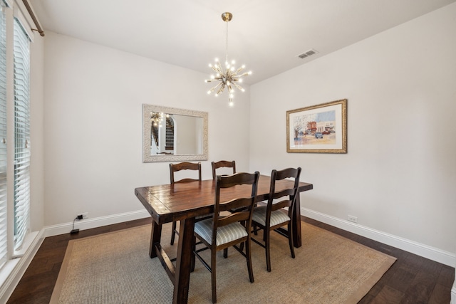 dining room featuring a chandelier, baseboards, visible vents, and dark wood-type flooring
