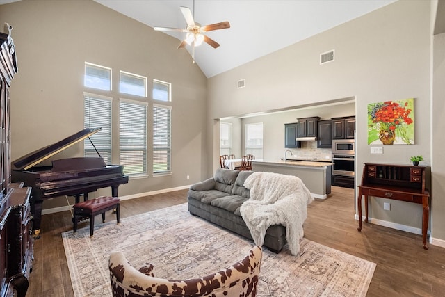 7809 Bella Way, Arlington, TX 76001 - living room featuring ceiling fan, high vaulted ceiling, light wood-type flooring, and baseboards