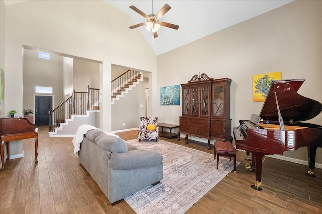 7809 Bella Way, Arlington, TX 76001 - living room featuring high vaulted ceiling, stairs, wood finished floors, a ceiling fan, and baseboards