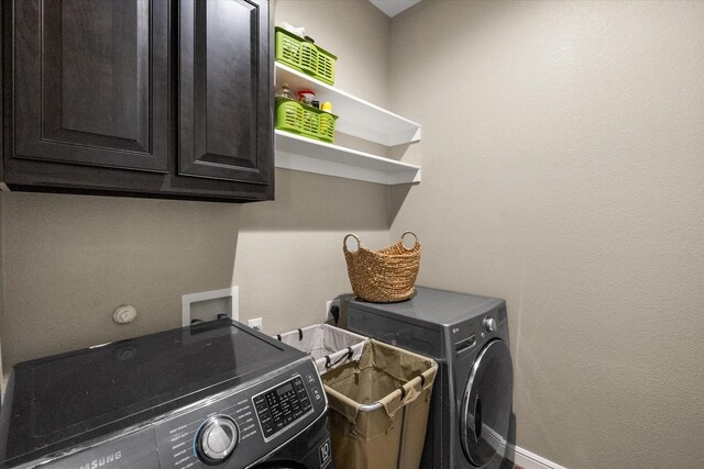7809 Bella Way, Arlington, TX 76001 - laundry room with washer and clothes dryer, baseboards, and cabinet space