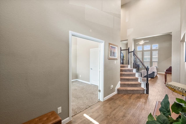 7809 Bella Way, Arlington, TX 76001 - entryway with stairway, wood finished floors, ceiling fan, baseboards, and a high ceiling