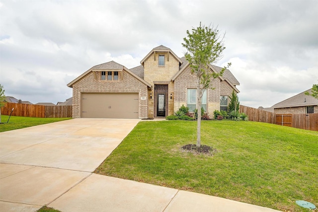 view of front of home featuring an attached garage, a front yard, and brick siding