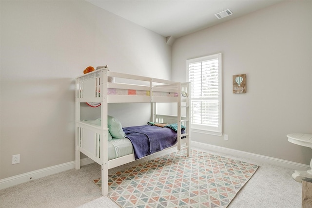 carpeted bedroom featuring baseboards and visible vents