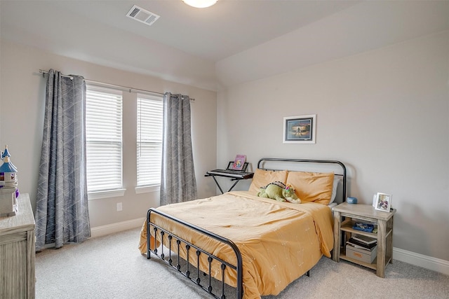 bedroom featuring baseboards, light colored carpet, and visible vents