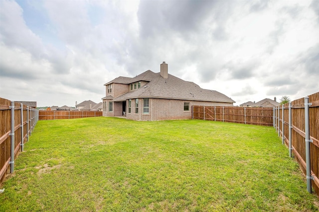 view of yard with a fenced backyard