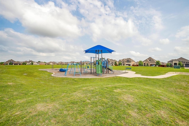 community jungle gym with a lawn and a residential view