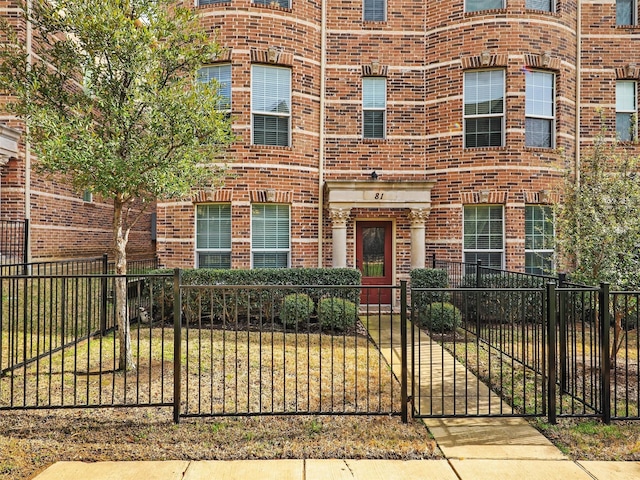 2500 Rockbrook Dr Unit 81, Lewisville, TX 75067 - view of property featuring brick siding and a fenced front yard