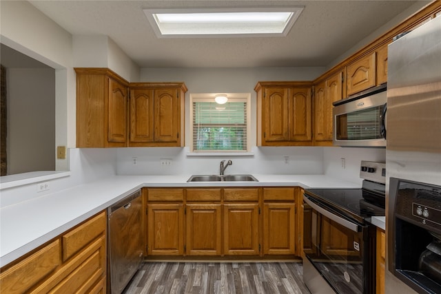 401 Mara Ln, Red Oak, TX 75154 - kitchen featuring brown cabinetry, a sink, and appliances with stainless steel finishes