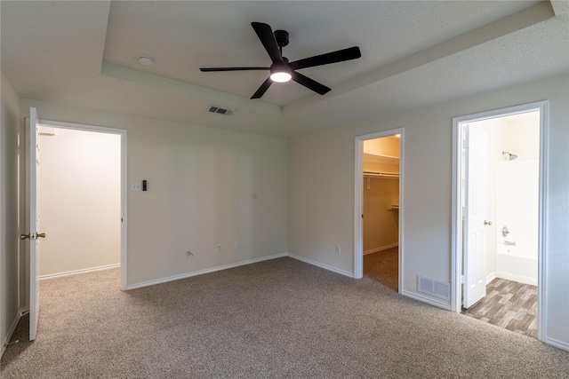 401 Mara Ln, Red Oak, TX 75154 - unfurnished bedroom with carpet floors, baseboards, visible vents, and a walk in closet