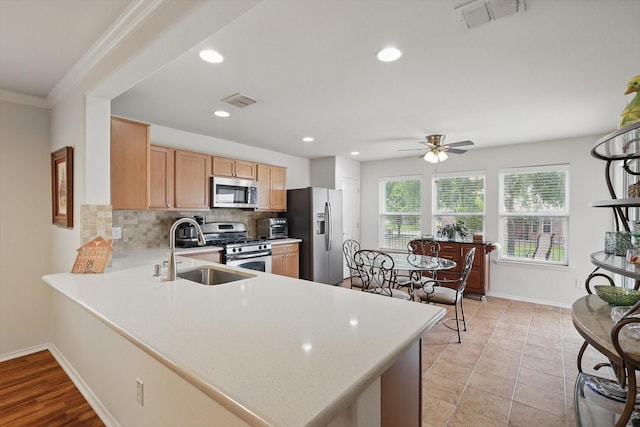 kitchen featuring visible vents, baseboards, light countertops, tasteful backsplash, and appliances with stainless steel finishes