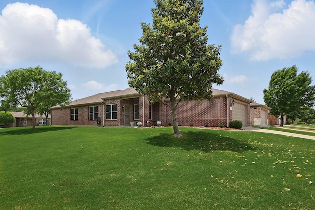 ranch-style house with a garage, concrete driveway, a front yard, and brick siding