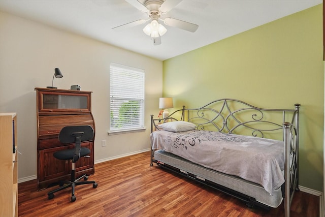 bedroom with baseboards, ceiling fan, and wood finished floors