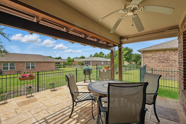 view of patio featuring fence, outdoor dining area, and ceiling fan