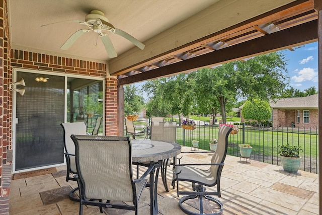 view of patio / terrace featuring outdoor dining area, a ceiling fan, and fence