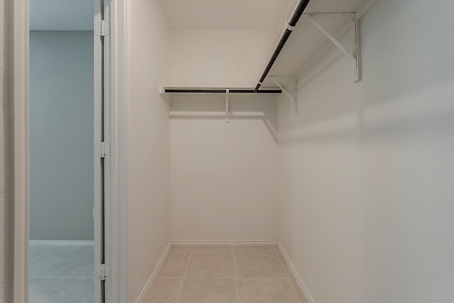 walk in closet featuring light tile patterned flooring